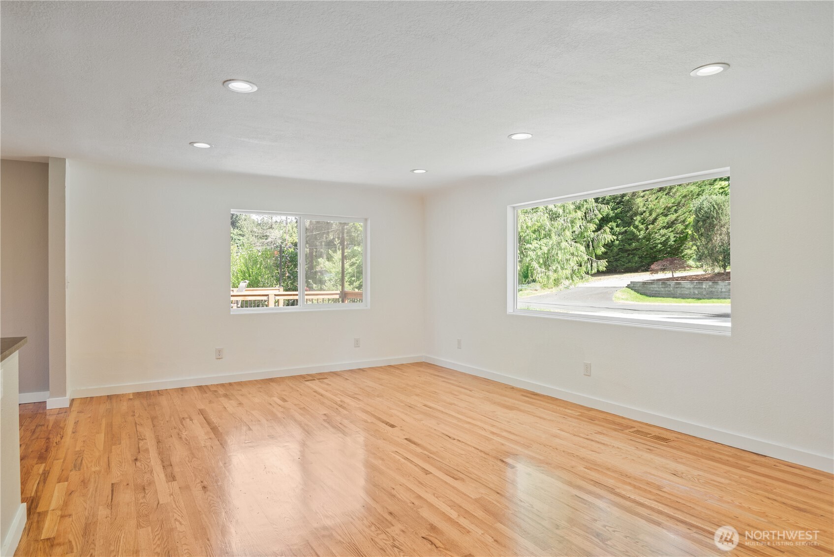 2903 Huntington Place Longview, WA 98632 - Photo 9 of 40 a view of an empty room with wooden floor and a window