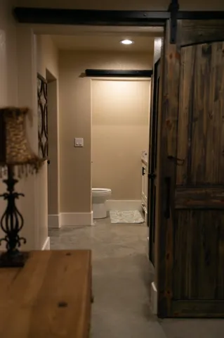 a bathroom with a toilet and a shower