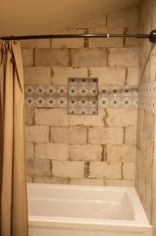 a bathroom with a bathtub and shower
