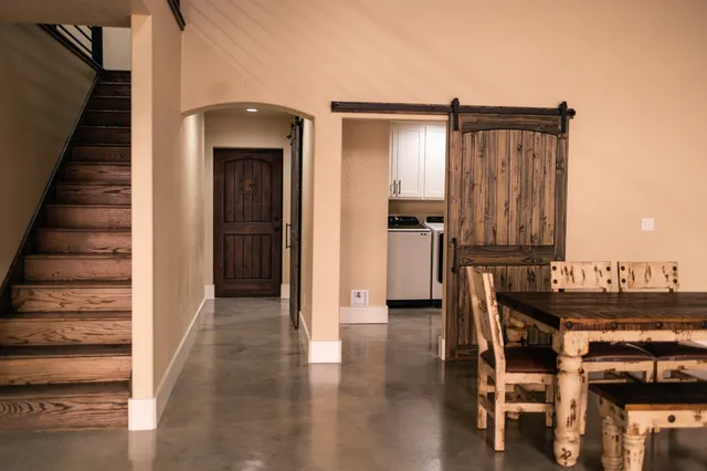 a view of a hallway with wooden floor and entryway