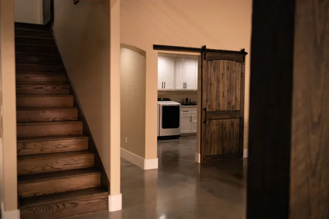 a view of entryway and kitchen with wooden floor