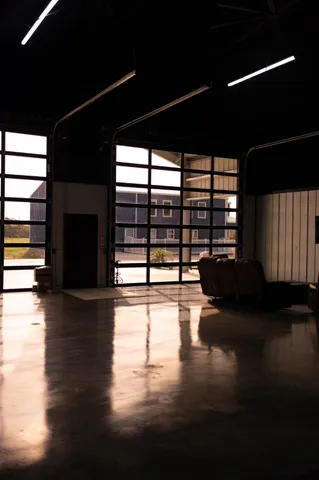 a view of empty room with wooden floor and windows