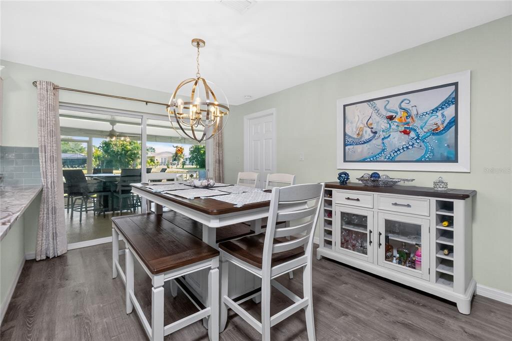 219 Caddy Road Rotonda West, FL 33947 - Photo 23 of 89 a view of a dining room with furniture window and wooden floor