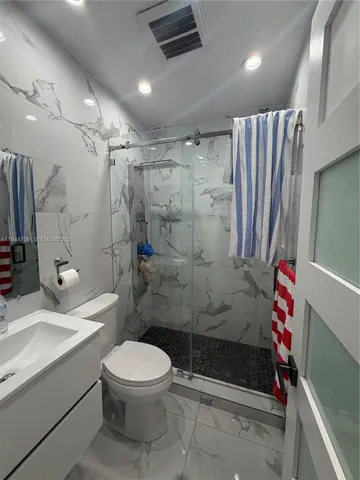 a bathroom with a sink toilet and shower