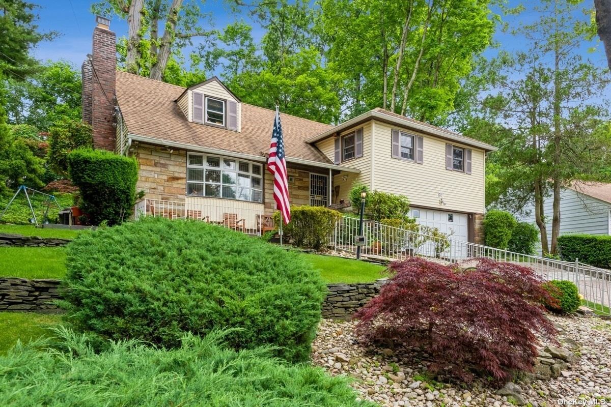 80 Beach Road Great Neck, NY 11023 - Photo 1 of 1 a front view of a house with a yard and garage