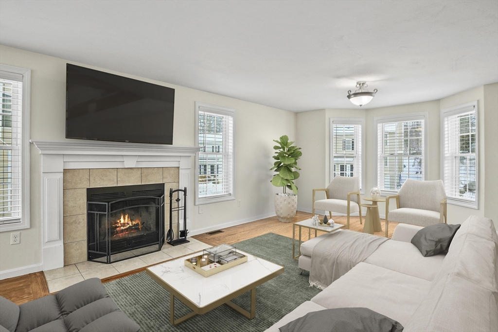 3 Lilac Lane Worcester, MA 01607 - Photo 3 of 30 a living room with furniture a flat screen tv and a fireplace