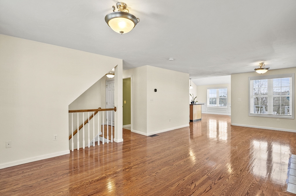 3 Lilac Lane Worcester, MA 01607 - Photo 6 of 30 a view of an empty room with wooden floor and a window