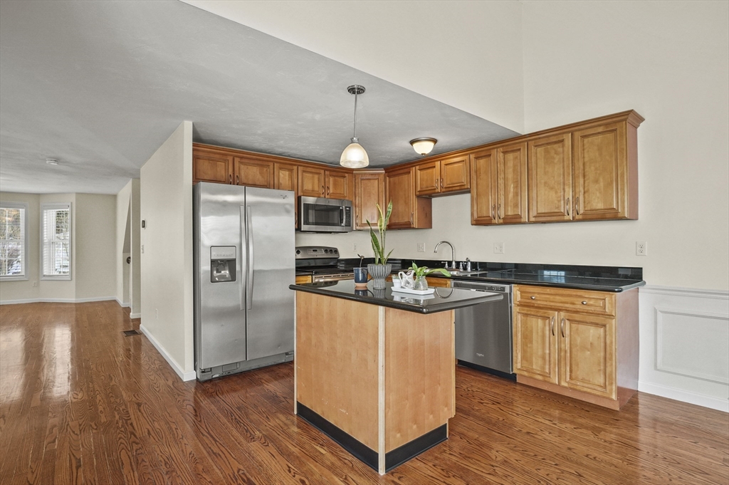 3 Lilac Lane Worcester, MA 01607 - Photo 7 of 30 a kitchen with stainless steel appliances granite countertop a refrigerator a sink dishwasher a stove and white countertops with wooden floor