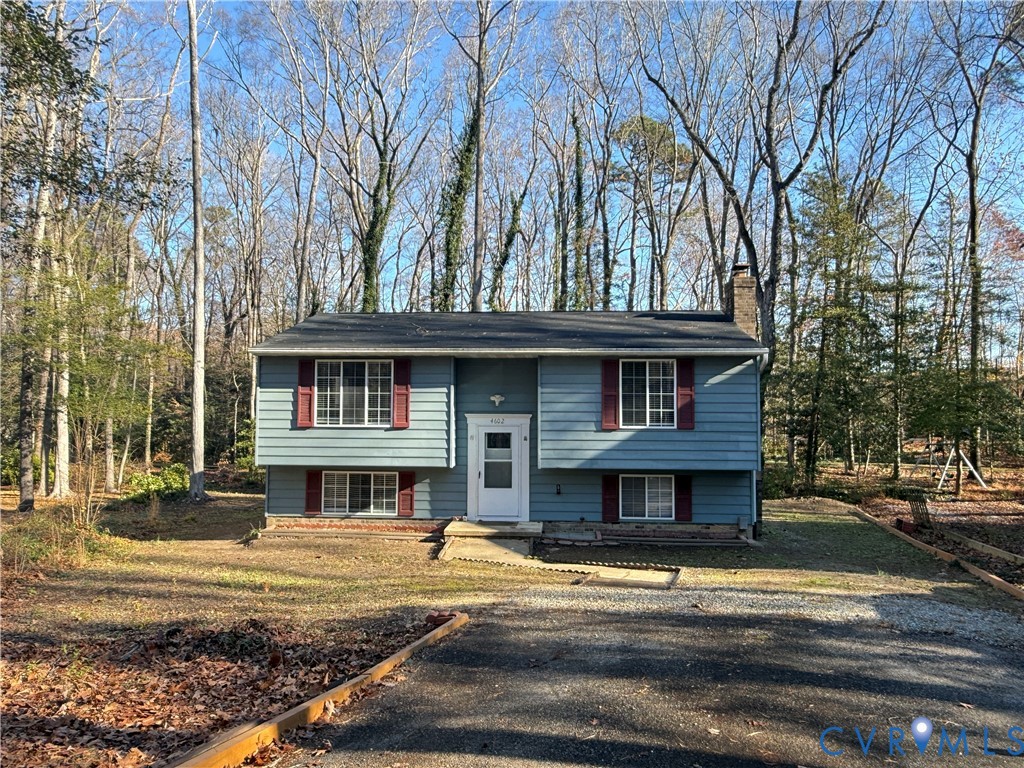 4602 Morning Hill Court Midlothian, VA 23112 - Photo 1 of 22 a front view of a house with a yard table and chairs