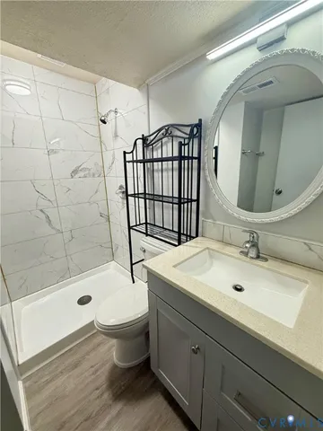 a bathroom with a sink toilet and shower