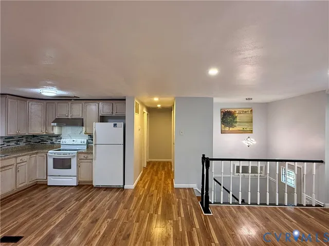 a kitchen with stainless steel appliances granite countertop a stove and a refrigerator
