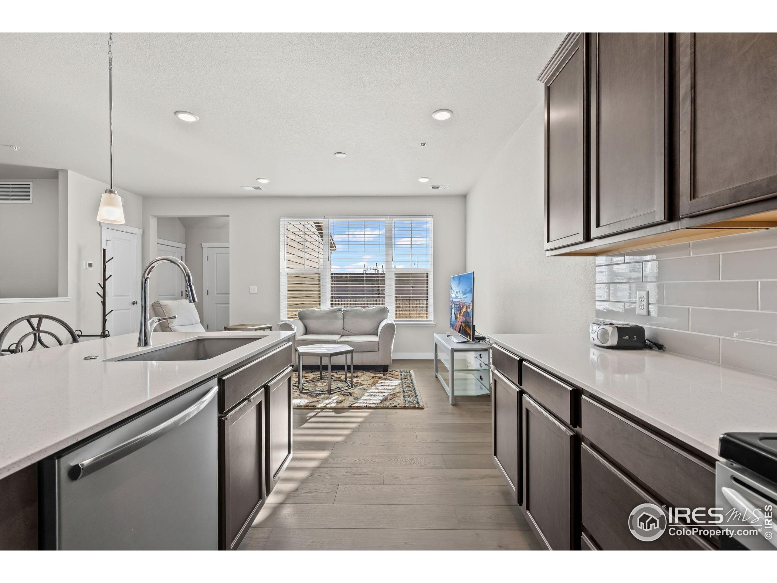 330 High Point Drive, Unit B103 Longmont, CO 80504 - Photo 11 of 18 a open kitchen with a sink and cabinets
