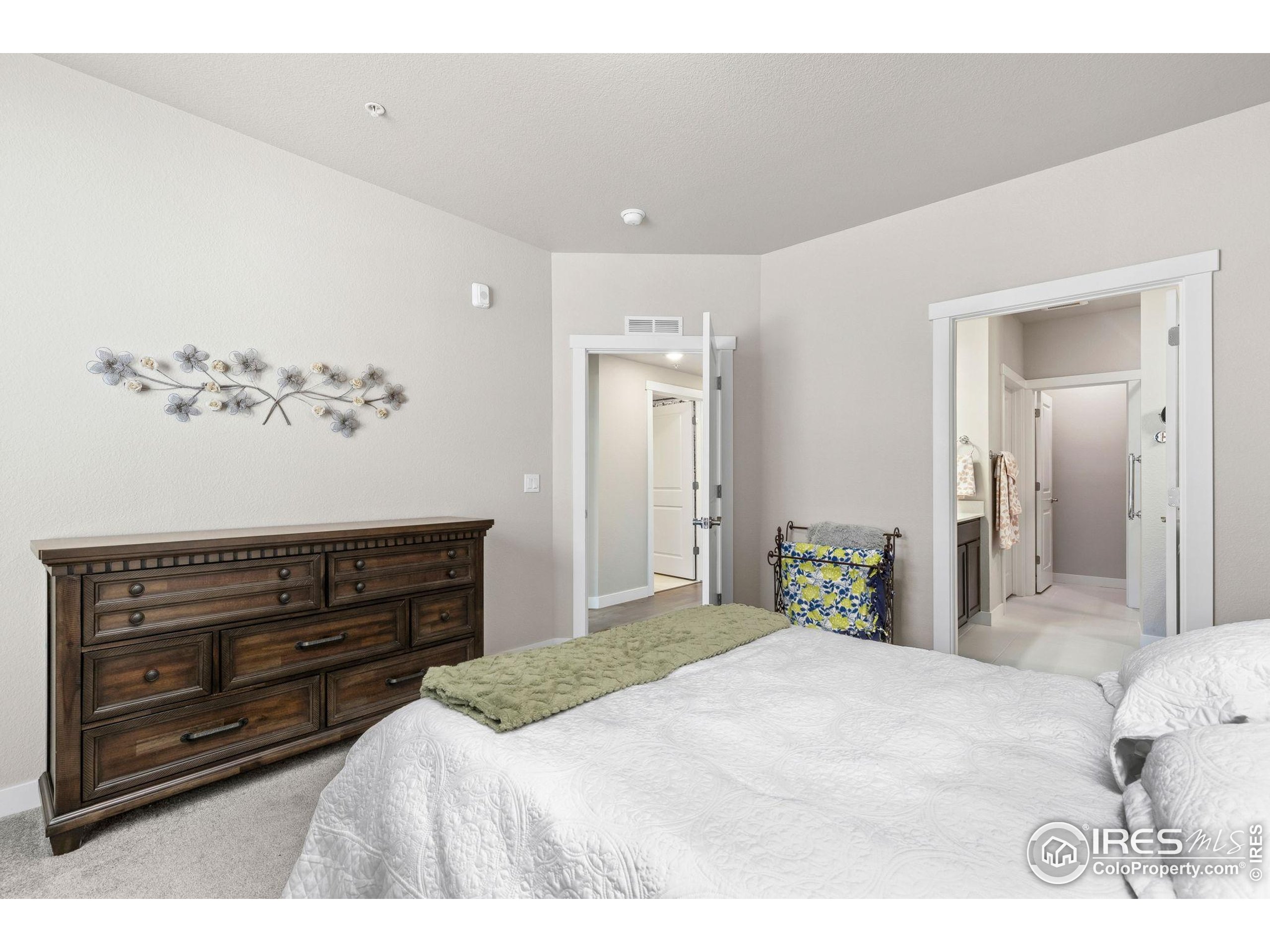 330 High Point Drive, Unit B103 Longmont, CO 80504 - Photo 13 of 18 a bedroom with a bed and a dresser