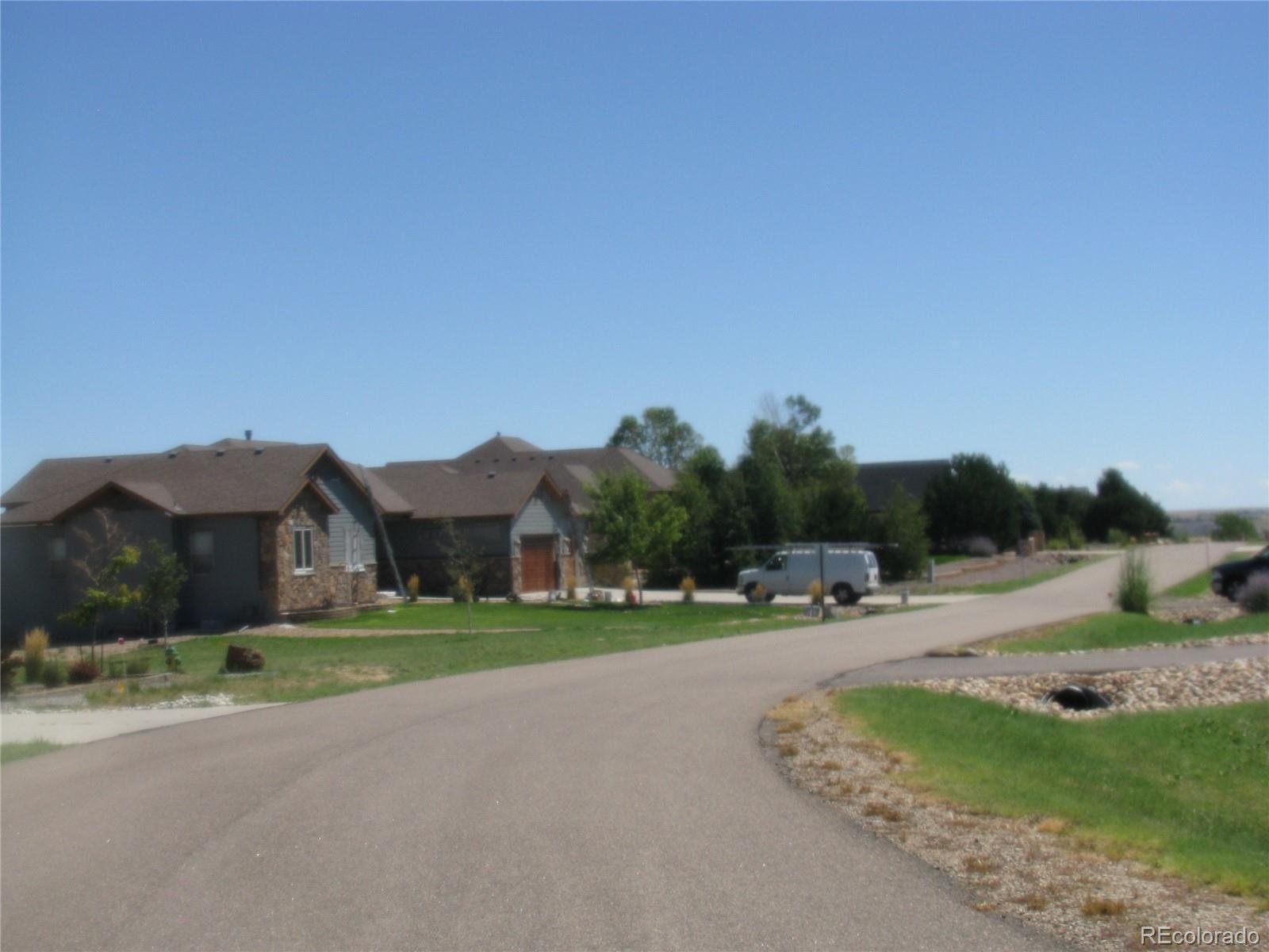 993 Pinehurst Court Bennett, CO 80102 - Photo 3 of 9 a view of city street with a house