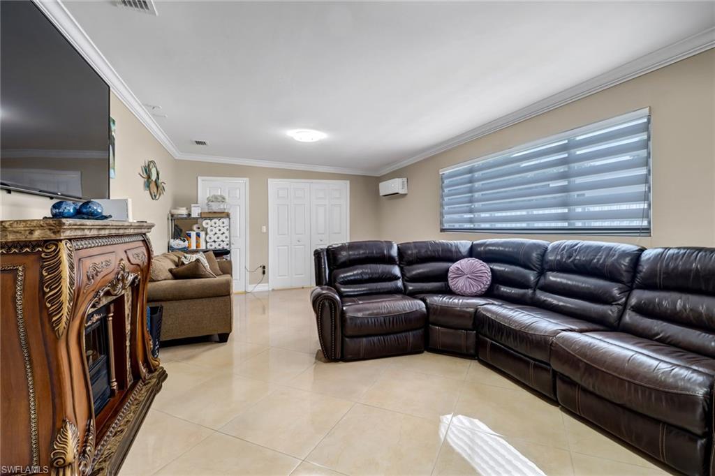 2001 43rd Terrace Southwest Naples, FL 34116 - Photo 17 of 27 a living room with furniture a washer and dryer