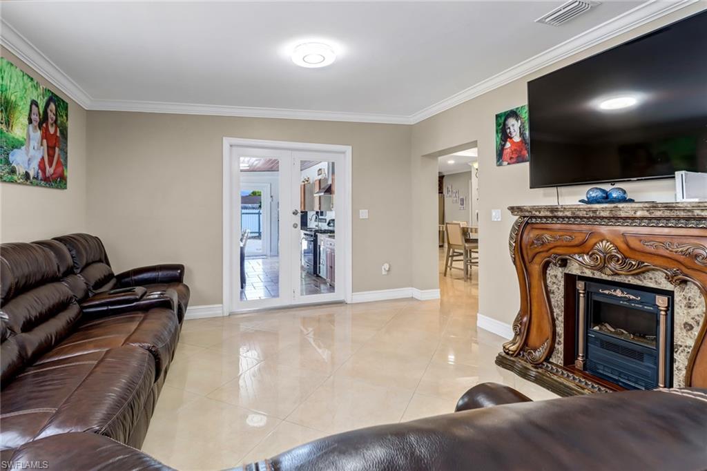 2001 43rd Terrace Southwest Naples, FL 34116 - Photo 18 of 27 a living room with furniture and a fireplace