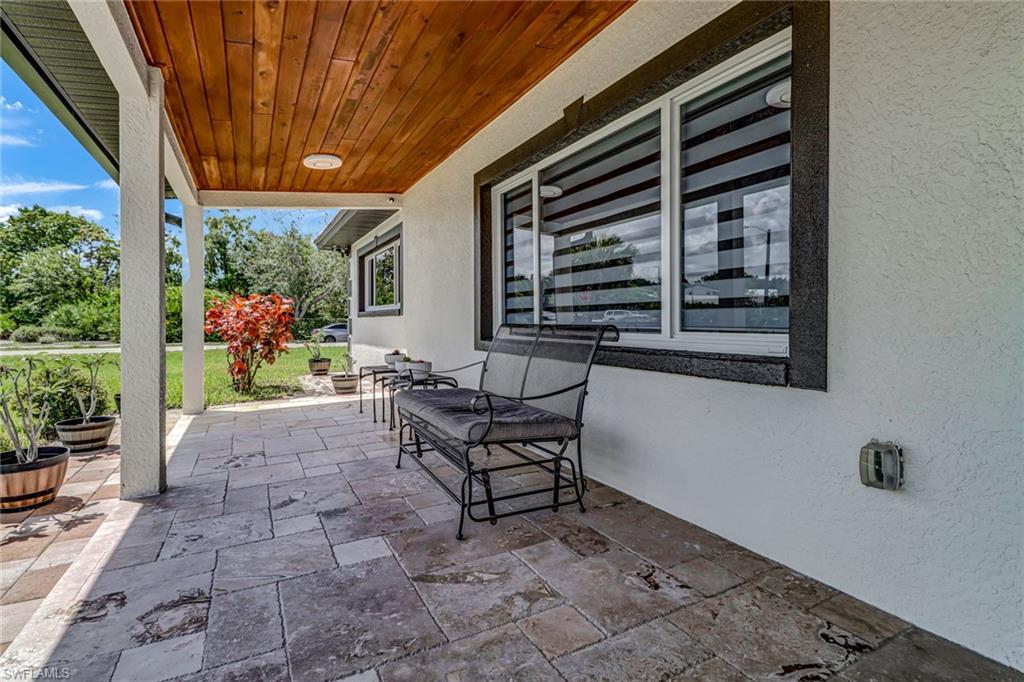 2001 43rd Terrace Southwest Naples, FL 34116 - Photo 4 of 27 a backyard of a house with outdoor seating