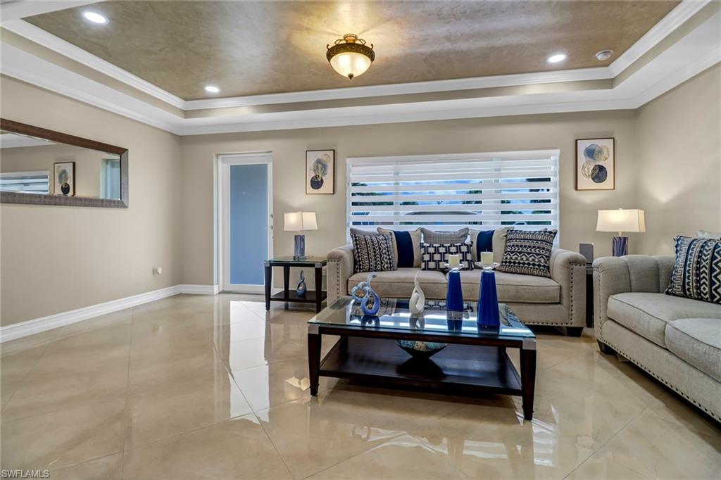 2001 43rd Terrace Southwest Naples, FL 34116 - Photo 6 of 27 a living room with furniture and a fireplace