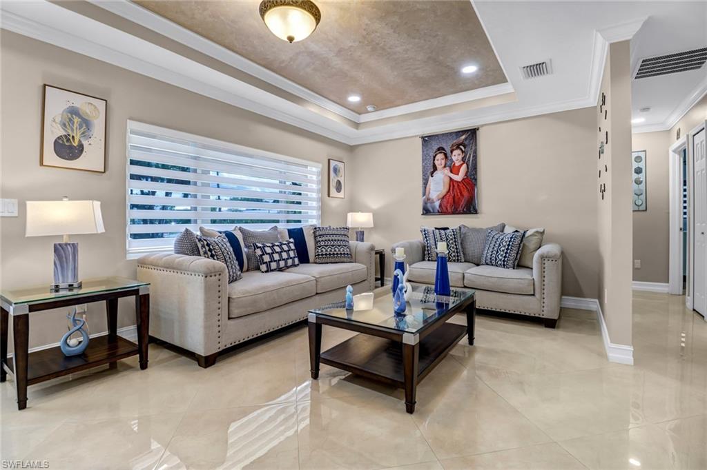 2001 43rd Terrace Southwest Naples, FL 34116 - Photo 7 of 27 a living room with furniture and a potted plant