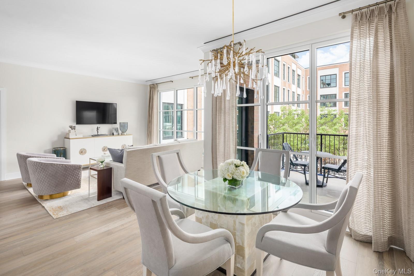 100 Garvies Point Road, Unit 1102 Glen Cove, NY 11542 - Photo 4 of 16 a dining room with furniture and window