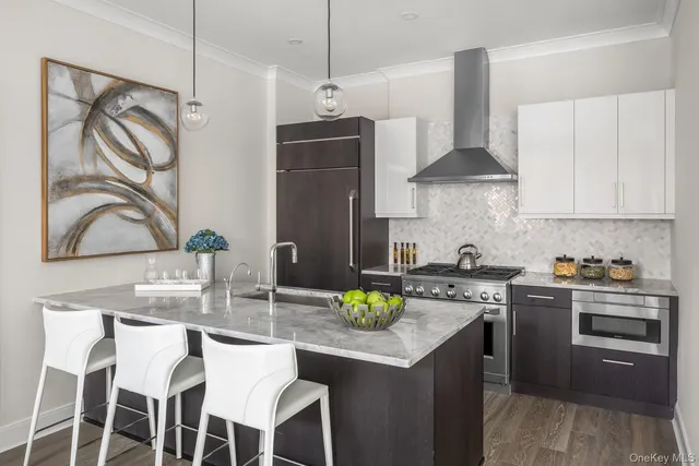 a kitchen with stainless steel appliances granite countertop a stove a sink and a refrigerator