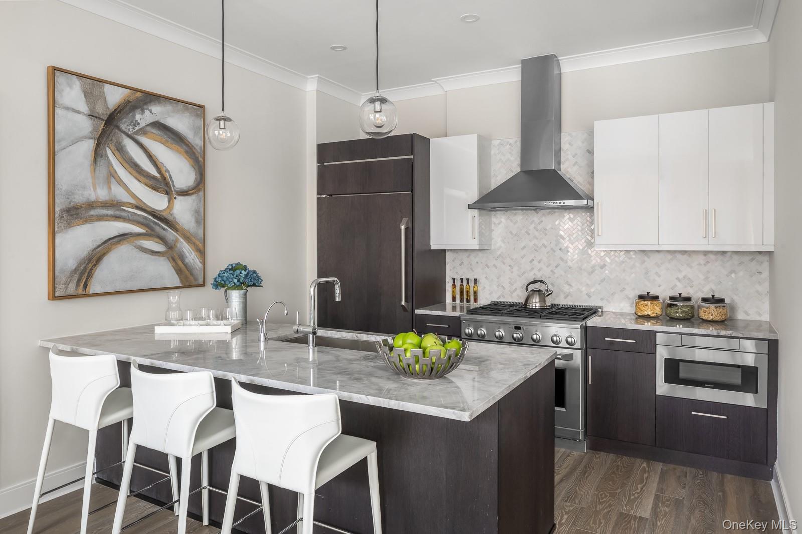 100 Garvies Point Road, Unit 1102 Glen Cove, NY 11542 - Photo 5 of 16 a kitchen with stainless steel appliances granite countertop a stove a sink and a refrigerator
