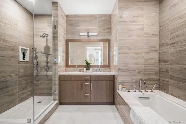a bathroom with a double vanity sink mirror and shower