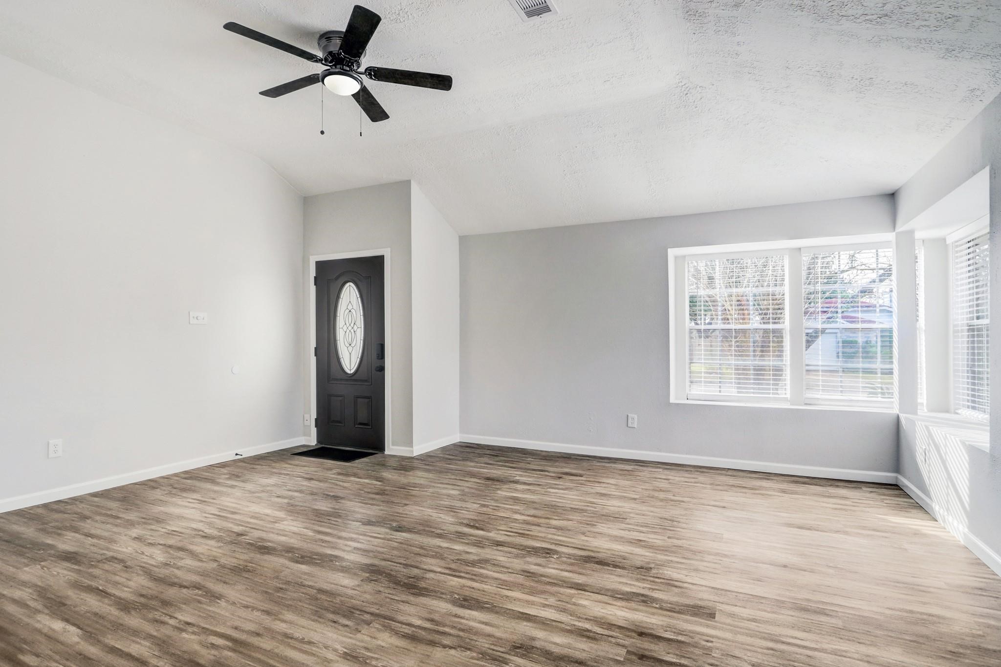 15910 Plover Court Humble, TX 77396 - Photo 2 of 10 wooden floor in an empty room with a window