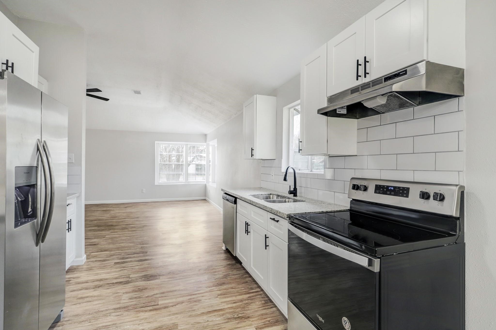 15910 Plover Court Humble, TX 77396 - Photo 4 of 10 a kitchen with stainless steel appliances a sink a stove a refrigerator and cabinets
