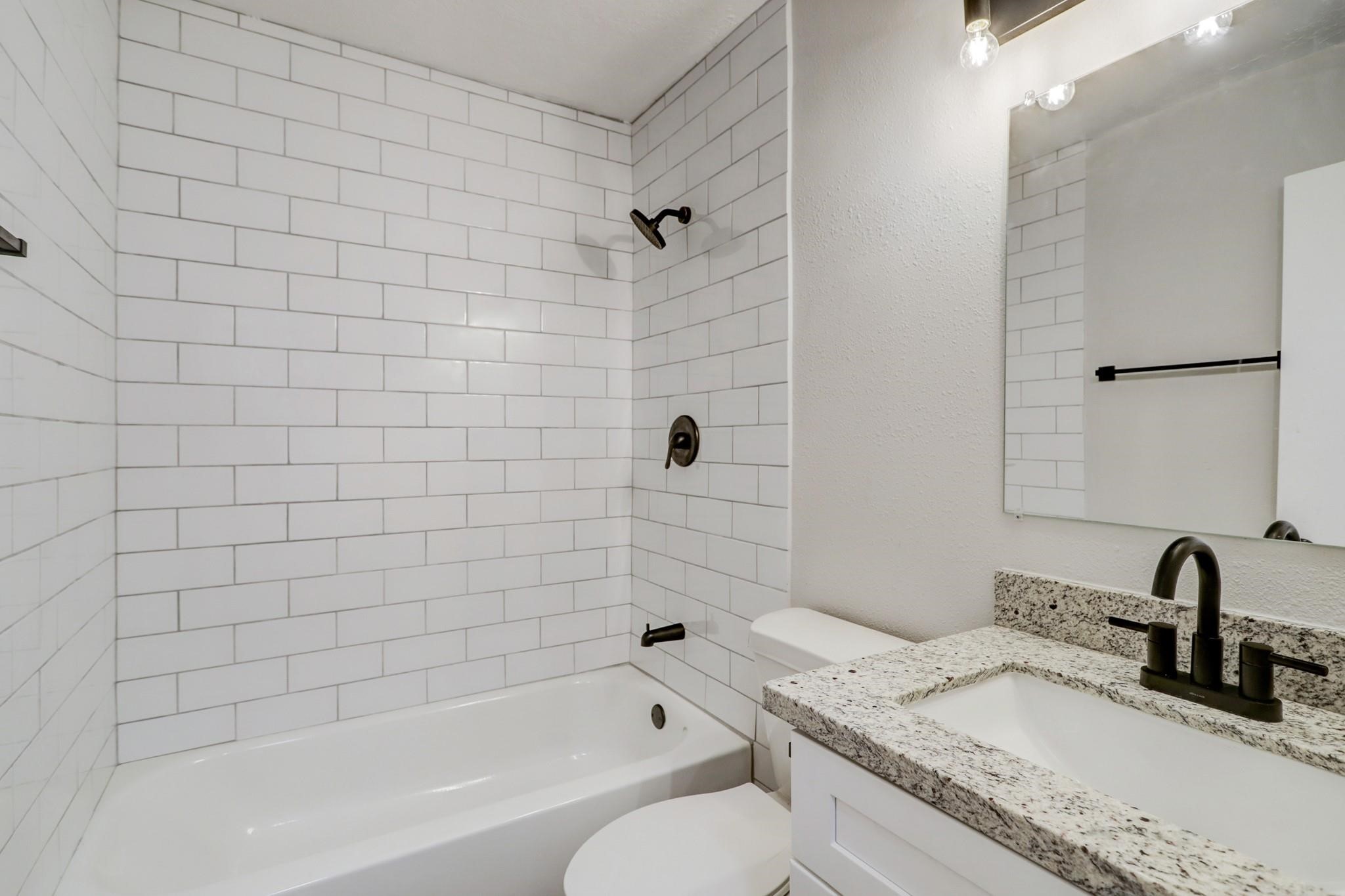15910 Plover Court Humble, TX 77396 - Photo 8 of 10 a bathroom with a granite countertop bathtub sink vanity and toilet