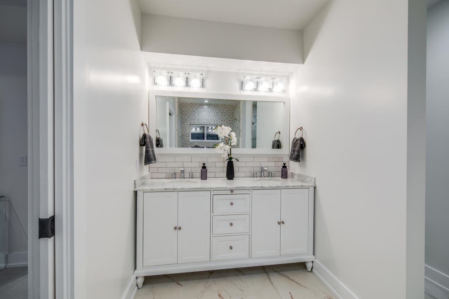 846 Portola Road Portola Valley, CA 94028 - Photo 43 of 80 a bathroom with a double vanity sink and a mirror