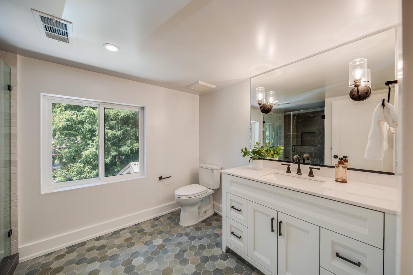 846 Portola Road Portola Valley, CA 94028 - Photo 55 of 80 a bathroom with a granite countertop toilet a sink and a mirror