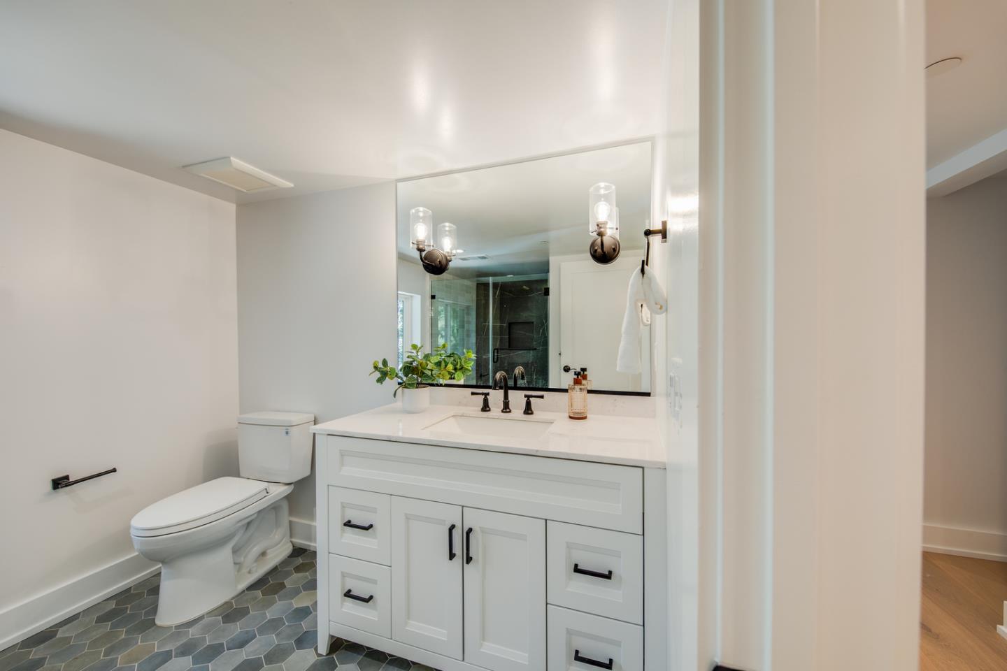 846 Portola Road Portola Valley, CA 94028 - Photo 56 of 80 a bathroom with a sink vanity mirror and toilet