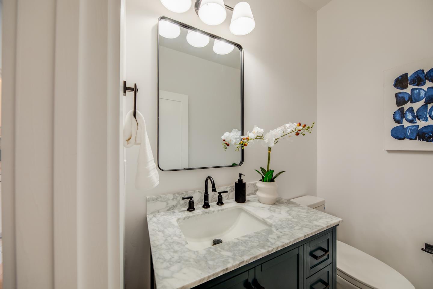 846 Portola Road Portola Valley, CA 94028 - Photo 68 of 80 a bathroom with a granite countertop sink and a mirror