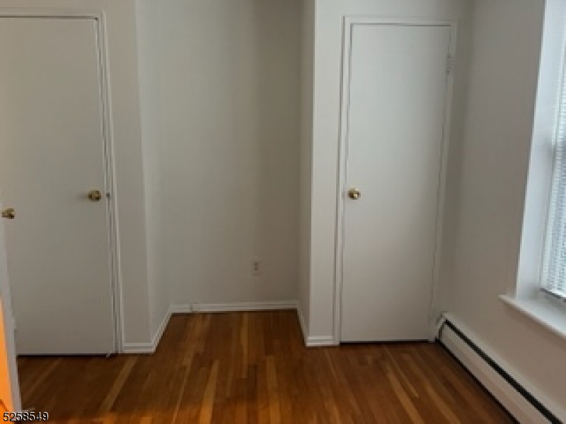 123 Milligan Place, Unit A South Orange, NJ 07079 - Photo 2 of 5 a view of a room with wooden floor and white walls
