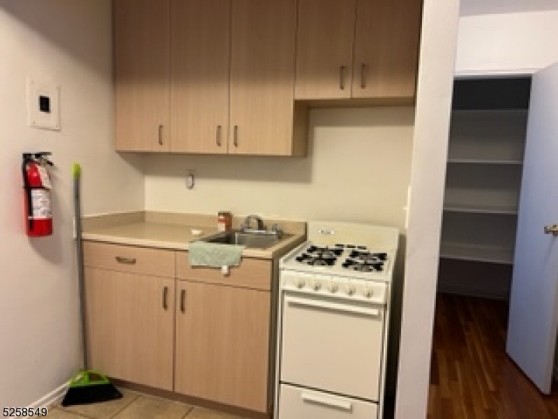 123 Milligan Place, Unit A South Orange, NJ 07079 - Photo 3 of 5 a kitchen with a stove and a refrigerator