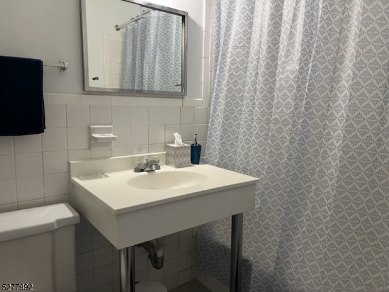 123 Milligan Place, Unit A South Orange, NJ 07079 - Photo 4 of 5 a sink and a table in a room