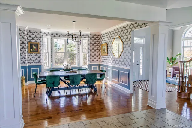 a dining room with furniture window and wooden floor