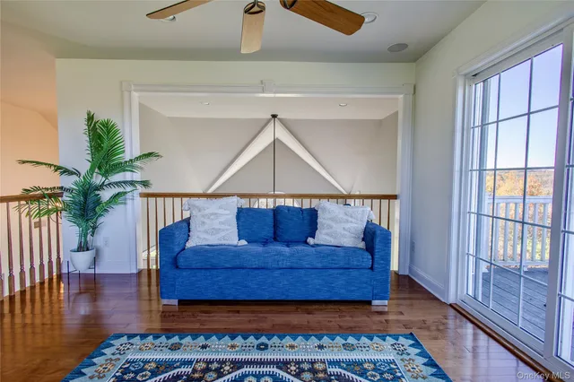 a living room with a couch and wooden floor