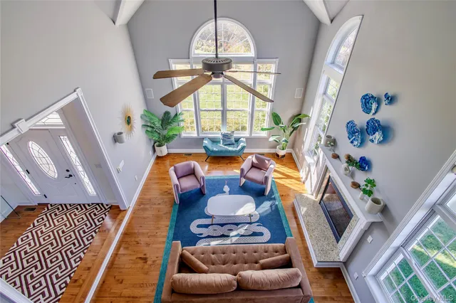 a living room with furniture fireplace and a large window
