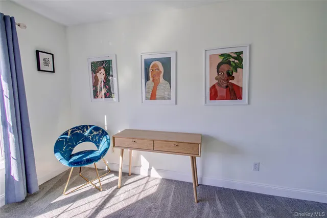 a living room with couch and painting on the wall