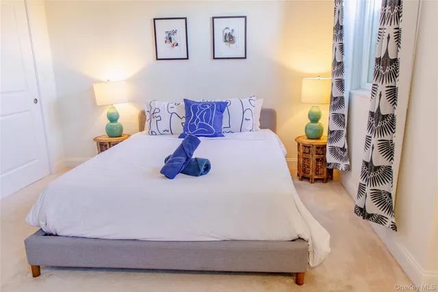 a bed sitting in a bedroom next to a window