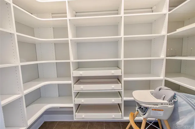 a view of a room with shelves and a ceiling fan
