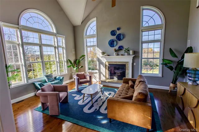 a living room with furniture fireplace and window