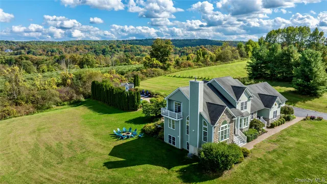 a view of a garden with a house in the background