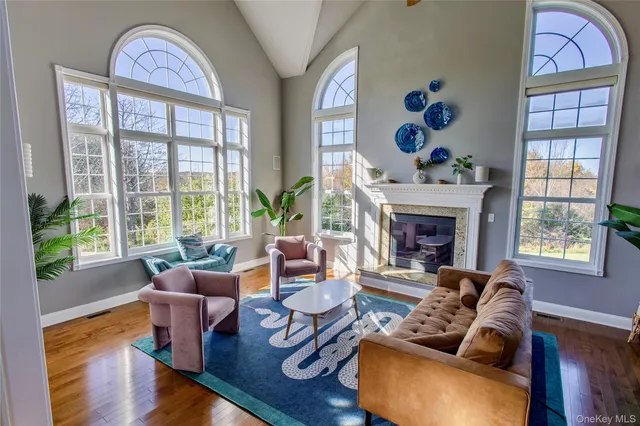 a living room with furniture fireplace and window