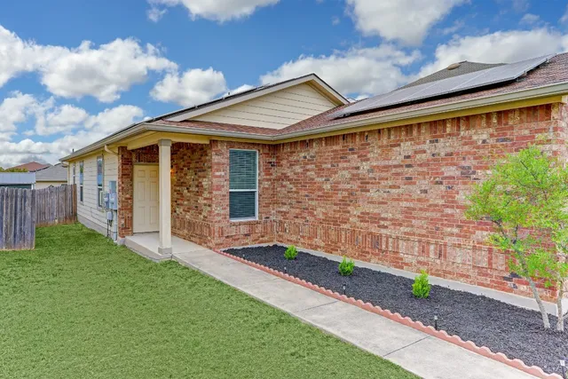 a front view of a house with garden