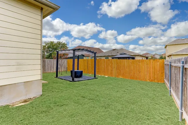 a view of a backyard with potted plants and a fountain