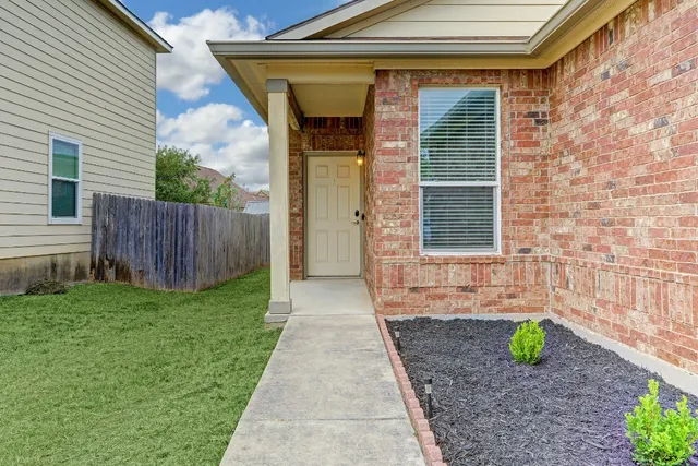 a view of front door of house with green space