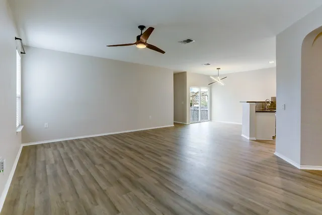 a view of empty room with wooden floor